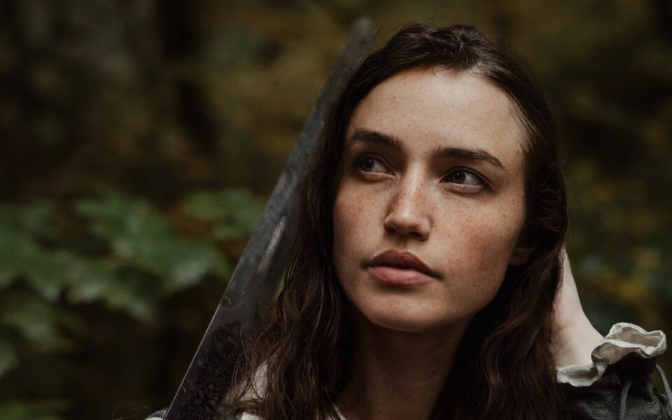 a woman dressed as a pirate holding a sword