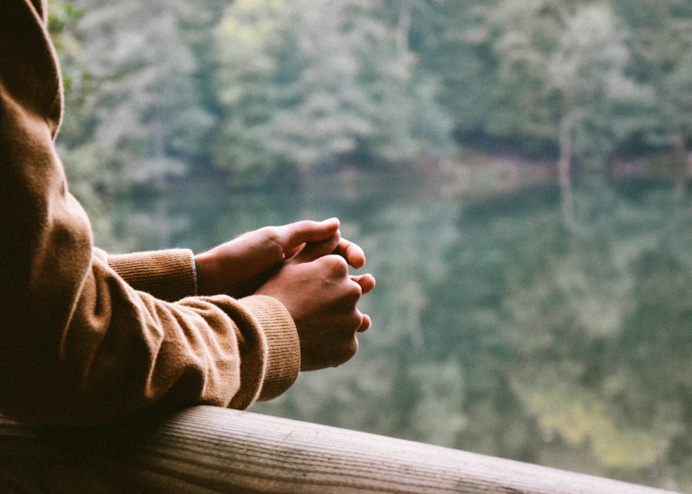 tilt-shift photography of person in brown jacket